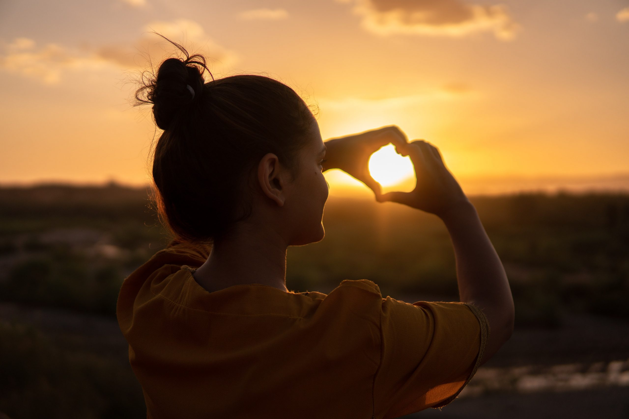 practice kindness - woman hands in a heart shape