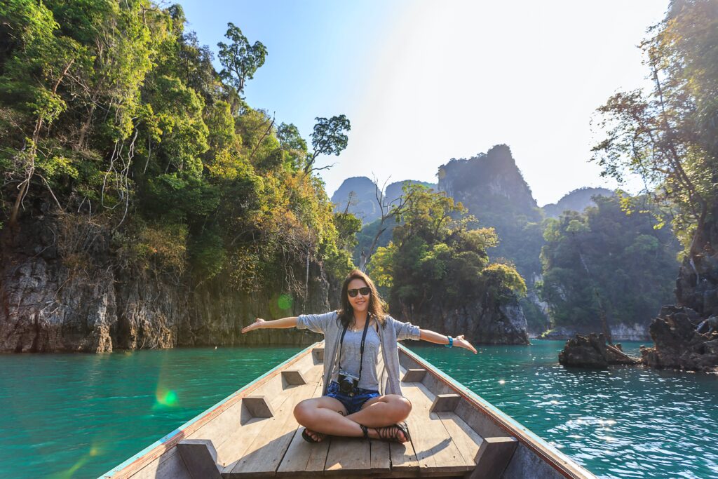 enneagram type and traveling - woman on an open boat in a tropical place